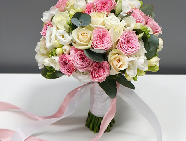 Bride's bouquet of pink spray roses, white roses, freesias and eucalyptus photo